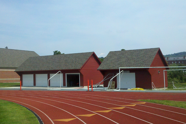 Storage shed with garage doors at athletic track